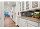 Bright and airy kitchen with white cabinetry, granite countertops, subway tile backsplash, and stainless steel appliances at 19973 W 94Th Ln, Arvada, CO 80007