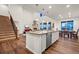 Modern kitchen with stainless steel appliances open to the living and dining spaces at 19973 W 94Th Ln, Arvada, CO 80007