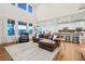 Bright living room with high ceilings, an open floor plan connecting to the kitchen, and large windows for ample light at 19973 W 94Th Ln, Arvada, CO 80007