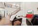 Comfortable living room featuring a staircase, television, fireplace, and views of the neighborhood at 19973 W 94Th Ln, Arvada, CO 80007