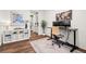 Bright office space with hardwood floors, white shelves, and views at 19973 W 94Th Ln, Arvada, CO 80007