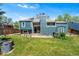 Spacious backyard with lush lawn, patio area, and a shed, perfect for outdoor living at 8370 W Evans Pl, Lakewood, CO 80227