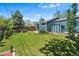 Expansive backyard with well-kept lawn, gardening area, and a storage shed at 8370 W Evans Pl, Lakewood, CO 80227