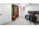 Finished basement area with built-in shelving, desk and computer, and a cozy ambiance at 8370 W Evans Pl, Lakewood, CO 80227