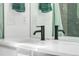 Close up of a bathroom vanity featuring a quartz countertop and a black faucet at 8370 W Evans Pl, Lakewood, CO 80227