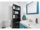 Bathroom featuring a blue vanity and a mirror at 8370 W Evans Pl, Lakewood, CO 80227