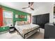 Comfortable bedroom featuring a ceiling fan, windows providing natural light and a black sliding-door closet at 8370 W Evans Pl, Lakewood, CO 80227
