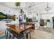 Bright, open dining area with modern lighting, colorful seating, and stylish decor creates a warm and inviting space at 8370 W Evans Pl, Lakewood, CO 80227