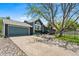 Charming home with a well-manicured lawn, mature trees, and a two-car garage at 8370 W Evans Pl, Lakewood, CO 80227