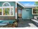 Stylish front entrance featuring a modern door, decorative plants, and a cozy bench, enhancing the home's curb appeal at 8370 W Evans Pl, Lakewood, CO 80227