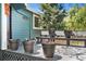 Inviting front porch with flower pots, bench and the house number is displayed by the front door at 8370 W Evans Pl, Lakewood, CO 80227