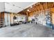 The spacious garage with exposed wood framing provides storage and workspace, with natural light at 8370 W Evans Pl, Lakewood, CO 80227