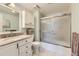 Bathroom featuring a shower-tub, vanity with granite countertop, and white cabinets at 7877 E Mississippi Ave # 506, Denver, CO 80247