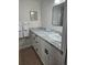 Bright bathroom featuring white vanity, granite countertop, and a modern rectangular mirror at 7877 E Mississippi Ave # 506, Denver, CO 80247