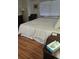 Comfortable bedroom with light wood floors, a window with blinds, and a ceiling fan at 7877 E Mississippi Ave # 506, Denver, CO 80247