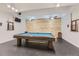 Recreational game room with a beautiful pool table, accented by unique wood-paneled walls and stylish lighting at 7877 E Mississippi Ave # 506, Denver, CO 80247