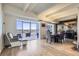 Open-concept living space with balcony access offering natural light and comfortable seating at 7877 E Mississippi Ave # 506, Denver, CO 80247