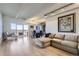 Bright living room featuring hardwood floors, modern lighting, and a balcony with views at 7877 E Mississippi Ave # 506, Denver, CO 80247