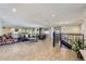 Spacious lobby with tile floors, lounge seating, and a decorative chandelier at 7877 E Mississippi Ave # 506, Denver, CO 80247