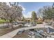 Picturesque pond with natural rock accents, serene landscaping, and community walking paths at 7877 E Mississippi Ave # 506, Denver, CO 80247