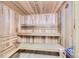 Relaxing sauna room featuring light wood paneling on the walls, ceiling, and benches at 7877 E Mississippi Ave # 506, Denver, CO 80247