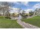 Scenic water feature with a calming fountain surrounded by lush landscaping and a pedestrian bridge at 7877 E Mississippi Ave # 506, Denver, CO 80247