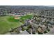 Wide aerial view of the neighborhood featuring green space, a baseball field and mature trees at 10052 Sage Sparrow Ct, Highlands Ranch, CO 80129
