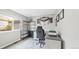 Cozy home office with a large window, a desk, a comfortable chair, and a storage shelf unit at 10052 Sage Sparrow Ct, Highlands Ranch, CO 80129