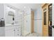 Bathroom featuring glass block shower, white vanity, and built-in sauna at 10052 Sage Sparrow Ct, Highlands Ranch, CO 80129