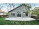 Charming home featuring a concrete patio, large windows, and sliding glass doors for seamless indoor-outdoor living at 10052 Sage Sparrow Ct, Highlands Ranch, CO 80129