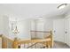 Upstairs hallway with wood railing, chandelier and closet doors at 10052 Sage Sparrow Ct, Highlands Ranch, CO 80129