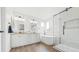 Bright bathroom with soaking tub, glass enclosed shower and double sink vanity at 10052 Sage Sparrow Ct, Highlands Ranch, CO 80129