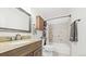 Bathroom with granite vanity and shower-tub combo at 10052 Sage Sparrow Ct, Highlands Ranch, CO 80129