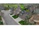 Aerial shot of a well-maintained home with solar panels in a neighborhood setting with green surroundings at 10052 Sage Sparrow Ct, Highlands Ranch, CO 80129