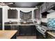 Modern kitchen with dark cabinetry, tile backsplash, and stainless steel appliances at 96 S Lindsey St, Castle Rock, CO 80104