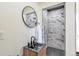 Modern bathroom with black fixtures, striking marble-look shower and unique black tiled floor at 1320 Locust St, Denver, CO 80220