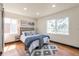 Bedroom with hardwood floors, two large windows, and a comfortable bed with decorative pillows at 1320 Locust St, Denver, CO 80220