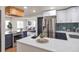 Bright, open kitchen with white counters, dark blue cabinets, stainless appliances and modern lighting at 1320 Locust St, Denver, CO 80220