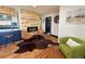 Open living area with hardwood floors, modern fireplace, comfortable seating, and seamless flow to kitchen at 1320 Locust St, Denver, CO 80220
