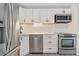 Modern kitchen featuring stainless steel appliances and white shaker cabinets at 165 S Sable Blvd # R14, Aurora, CO 80012