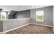 Spacious bonus room featuring neutral decor, carpeted floors, a window with natural light, and a lofted architectural feature at 8835 Edinburgh Cir, Highlands Ranch, CO 80129