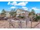 Inviting home with a large yard and mature trees beneath a bright blue sky at 8835 Edinburgh Cir, Highlands Ranch, CO 80129