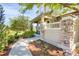 Charming porch with stone pillars, cozy seating and a well-manicured garden at 8835 Edinburgh Cir, Highlands Ranch, CO 80129