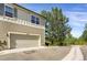 Attached garage with a driveway, set within a community with mature trees at 8835 Edinburgh Cir, Highlands Ranch, CO 80129