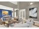 Bright living room featuring a large sofa and open layout to the kitchen at 8835 Edinburgh Cir, Highlands Ranch, CO 80129