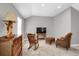 Comfortable living room features cozy seating, a wooden rocking chair, TV, carpeted floors, and a textured lamp at 8835 Edinburgh Cir, Highlands Ranch, CO 80129