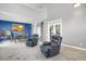 Spacious living room with comfortable recliners and an open layout to the kitchen at 8835 Edinburgh Cir, Highlands Ranch, CO 80129