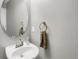 This powder room has an oval mirror, a neutral color palette, and a modern sink at 8835 Edinburgh Cir, Highlands Ranch, CO 80129