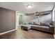 A gray couch can be seen in this finished basement which has laminate wood floors at 4117 S Mobile Cir # C, Aurora, CO 80013
