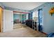 A colorful bedroom featuring blue walls, a storage area, and window with natural light at 4117 S Mobile Cir # C, Aurora, CO 80013